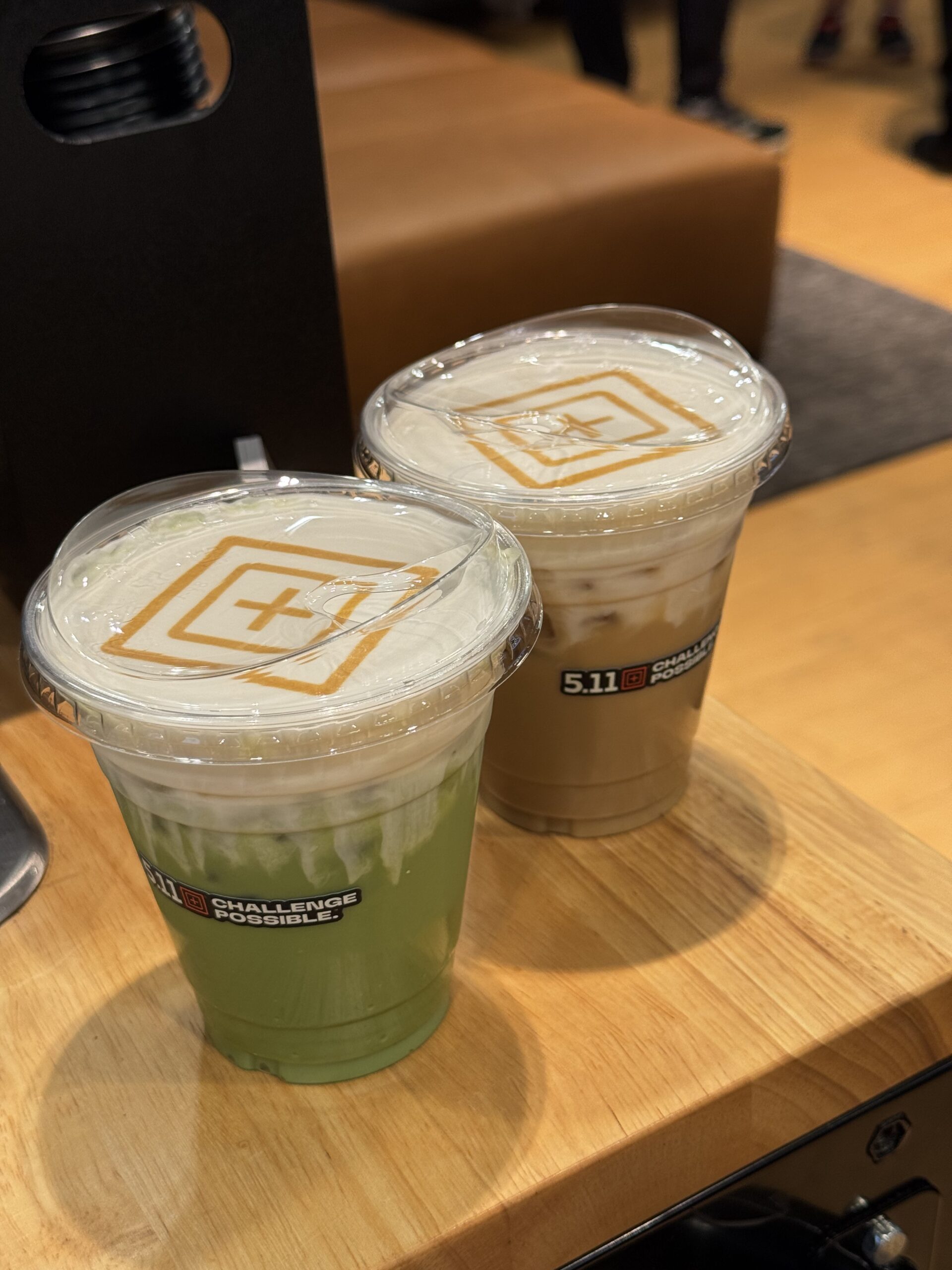 Iced latte and iced matcha with a company logo on top of cold foam for a brand activation coffee cart in Los Angeles