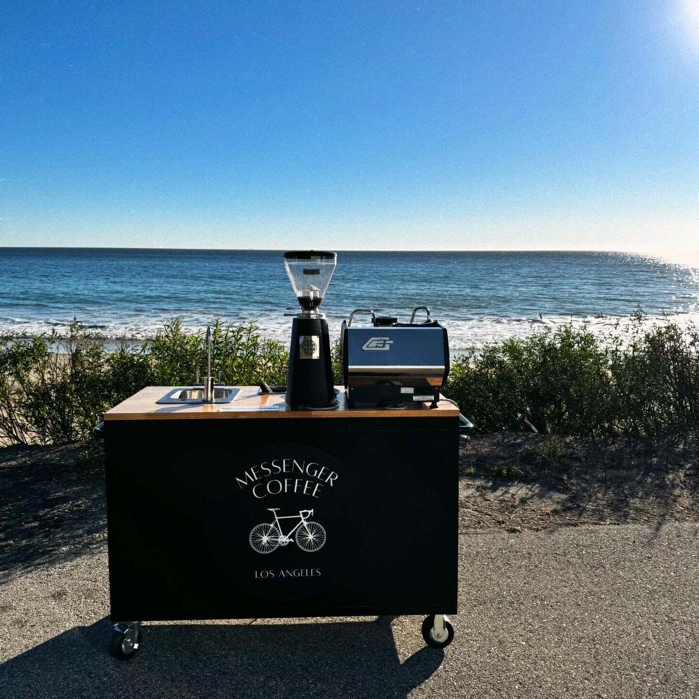 Mobile coffee cart by a beach in Los Angeles serving hot and iced lattes to a production crew on set