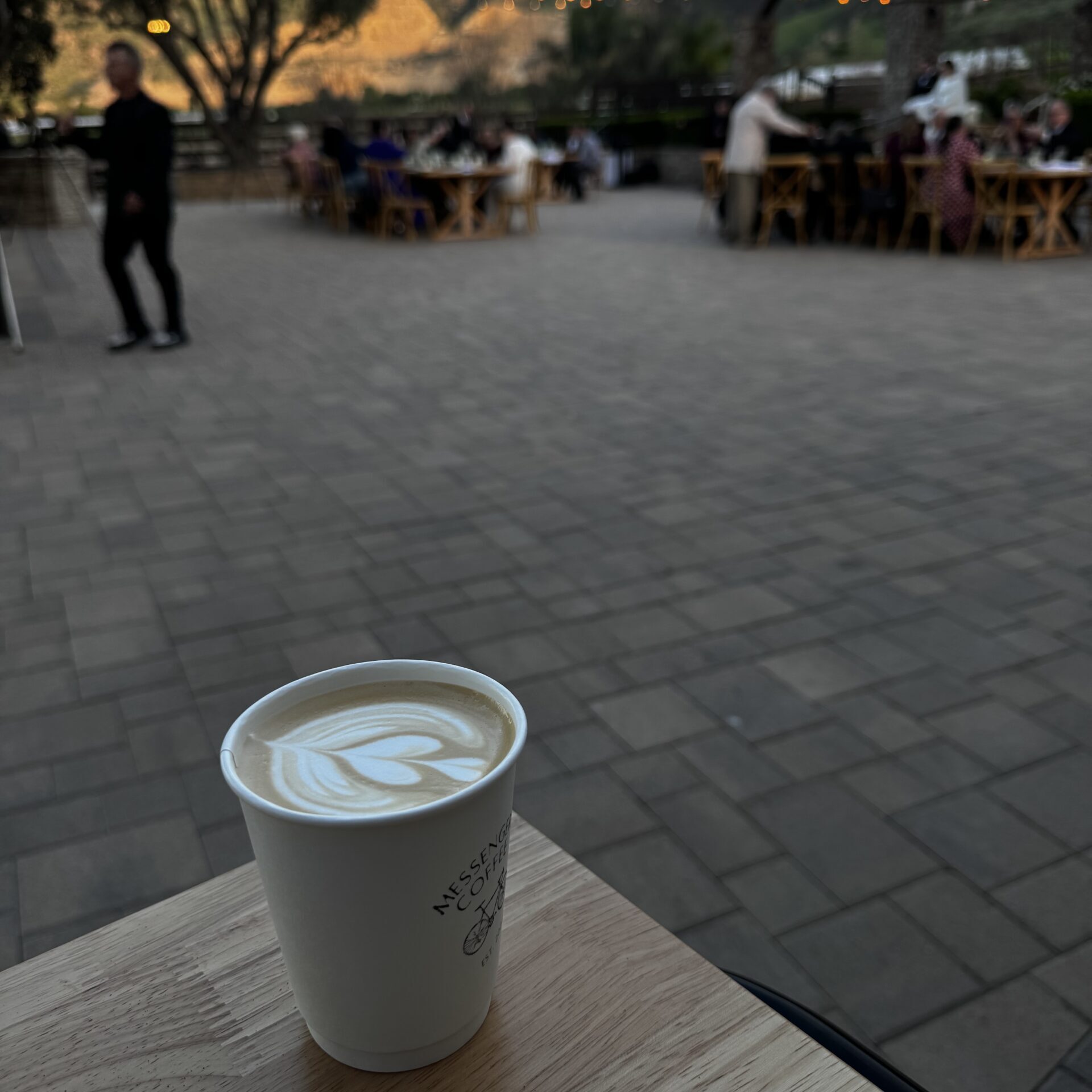 A hot latte with latte art on top of a coffee cart cart serving hot and iced lattes at a wedding in Ventura County