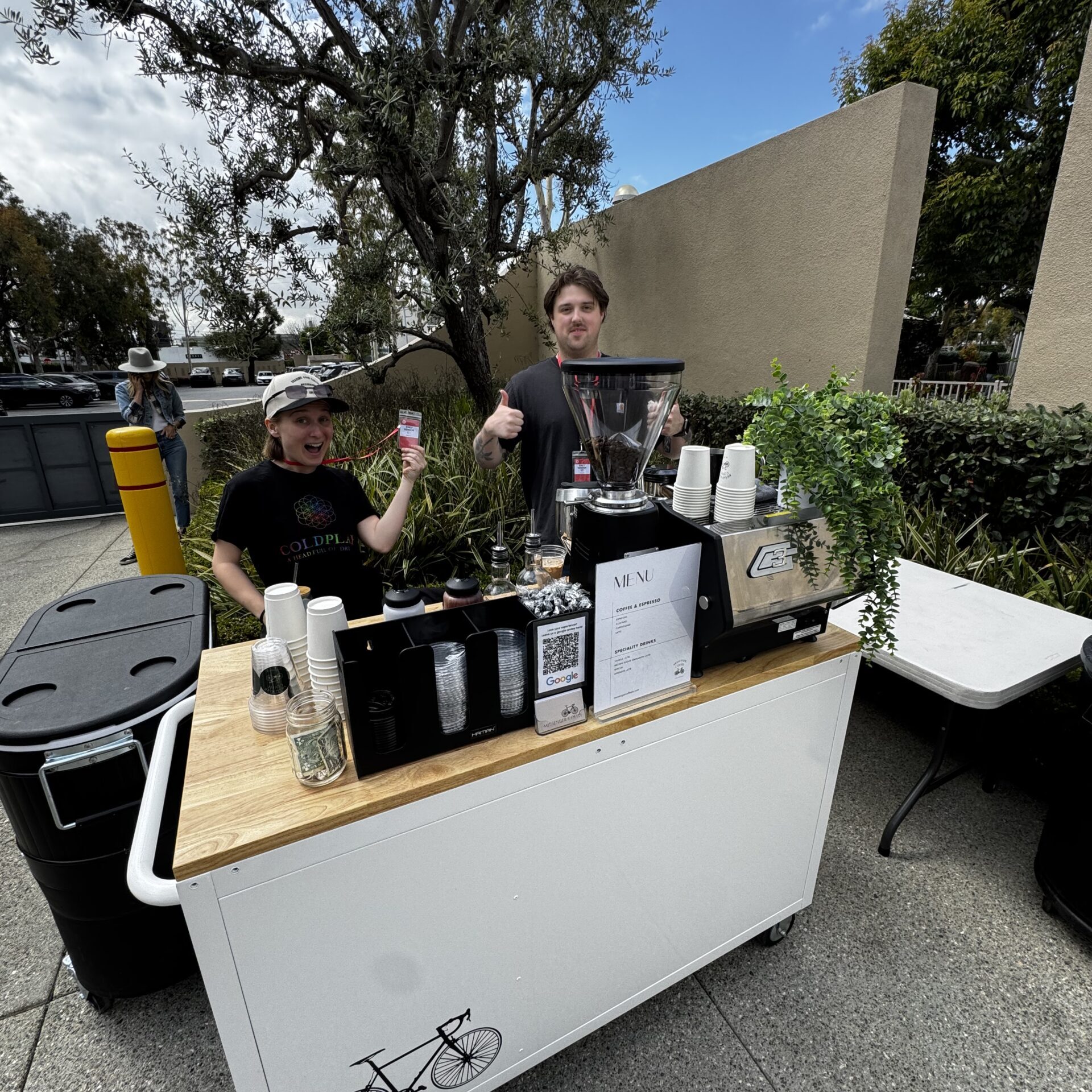Friendly baristas working a coffee cart serving lattes for a school function in Los Angeles