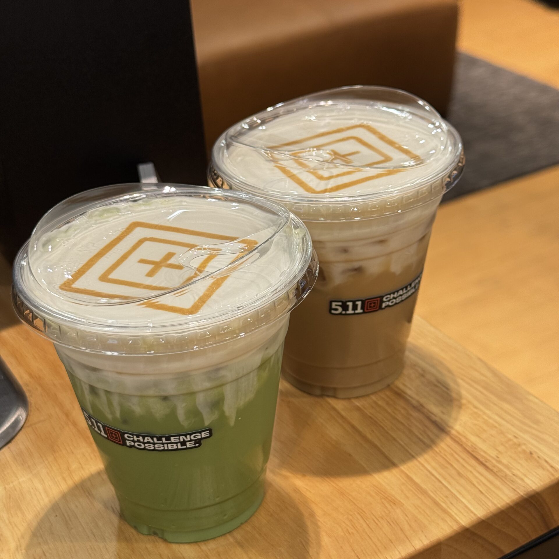 Iced latte and iced matcha with a company logo on top of cold foam for a brand activation coffee cart in Los Angeles